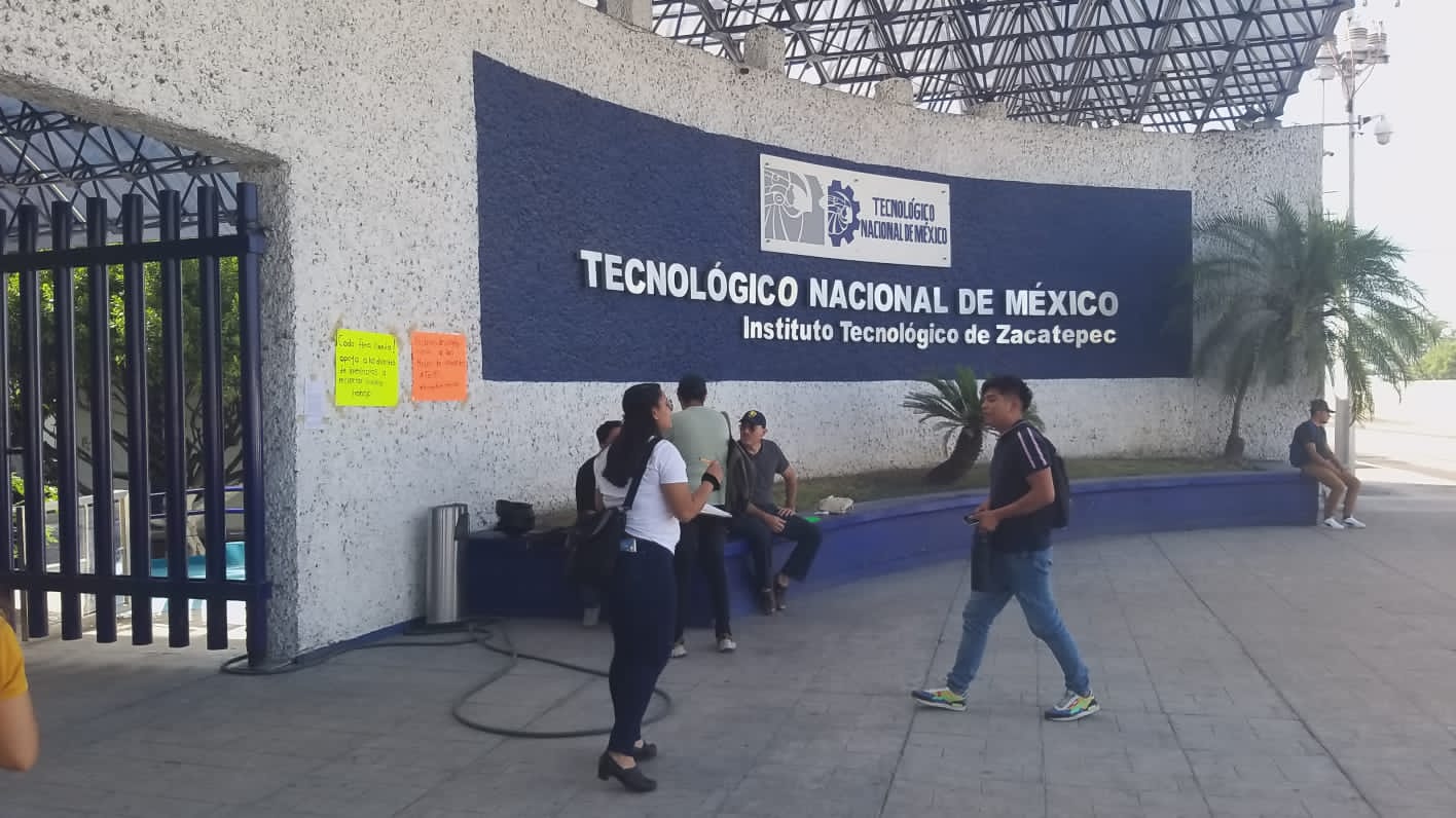 Un grupo de personas caminando junto a un edificio Descripción generada automáticamente con confianza media